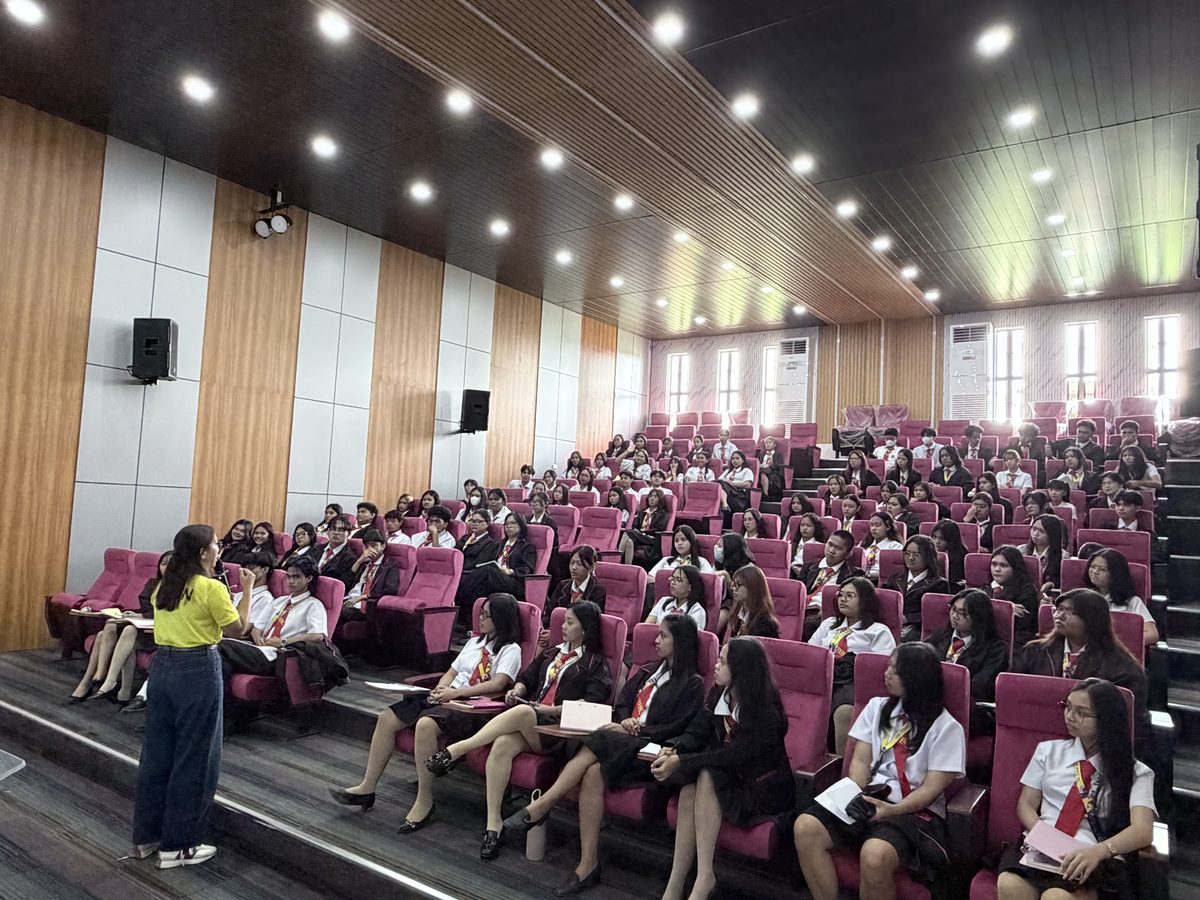 Close view of the mauve upholstered seating in Arcinas Hall with guests seated during an event.